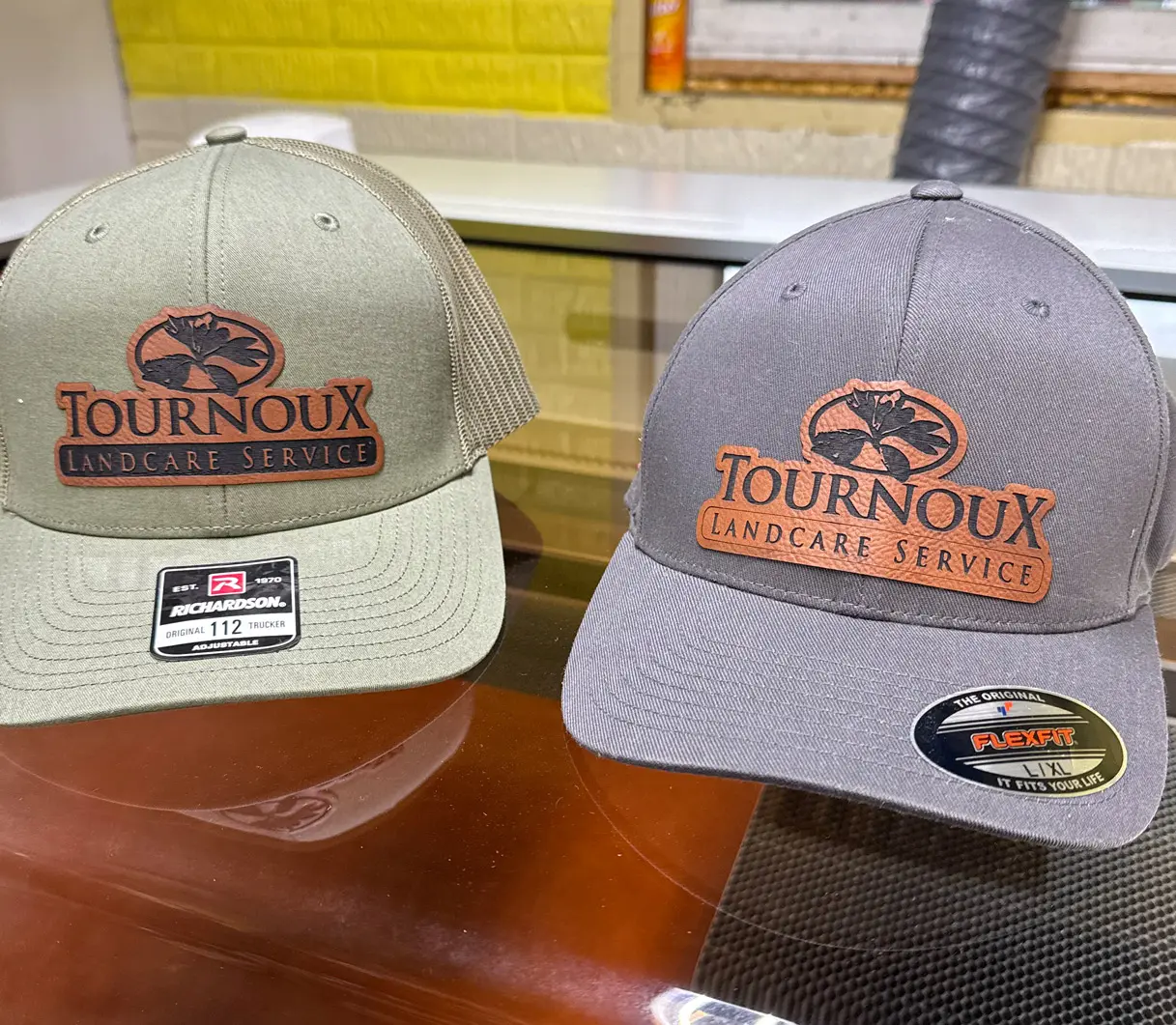 Two hats are sitting on a table.