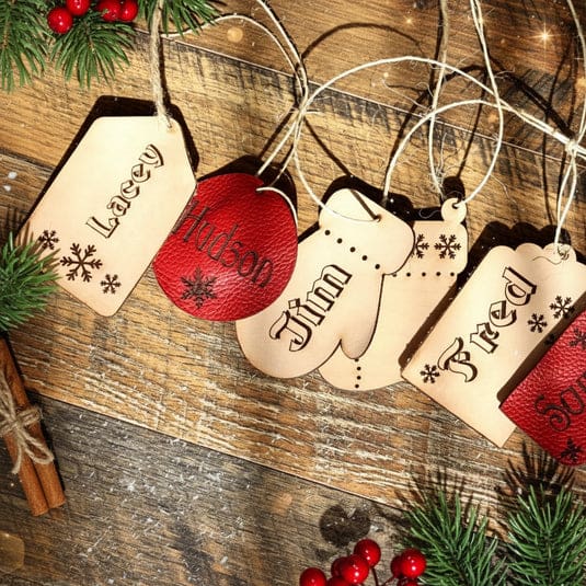 Wooden Christmas tags with festive decorations.